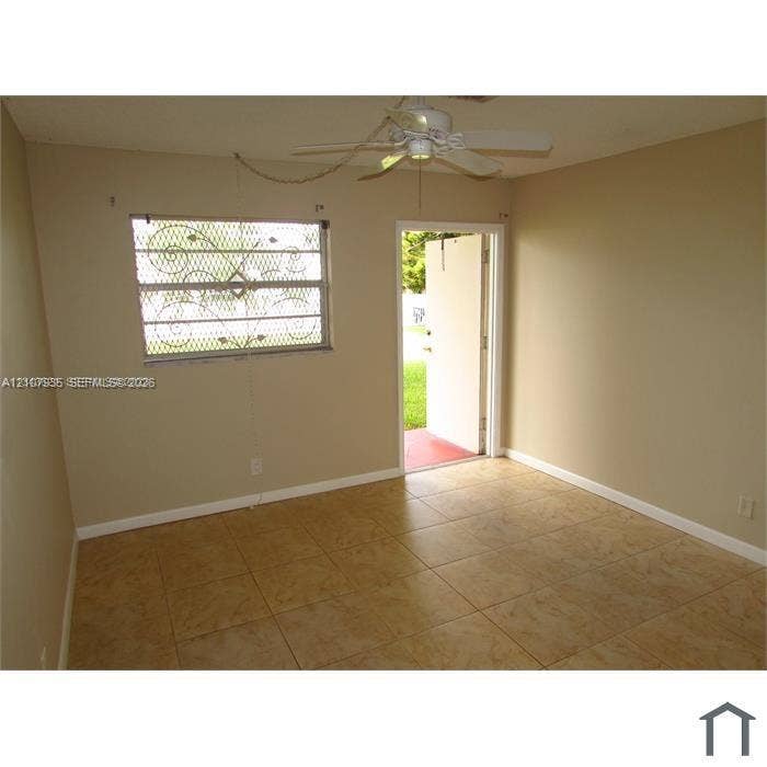 2839 Taylor Street, #3, Hollywood, Hollywood, FL 33020 Ceramic tile flooring, ceiling fan with integrated lighting, and window with decorative metal security screening