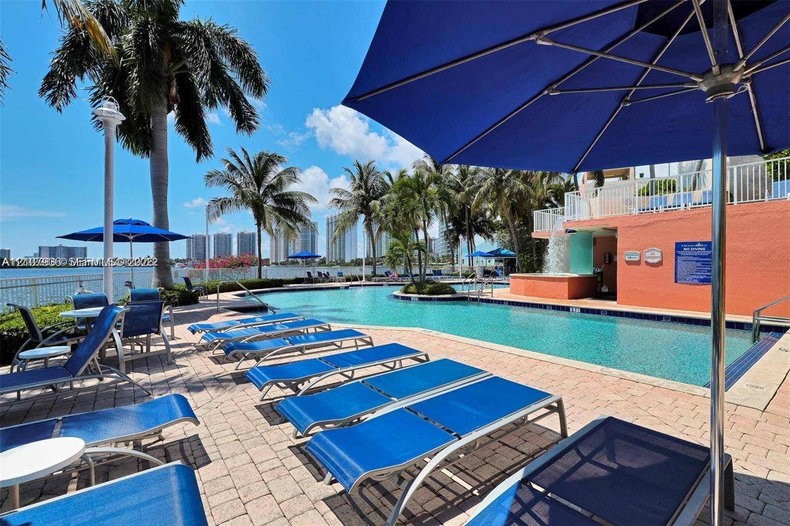 3370 Hidden Bay Drive, #510, Aventura, FL 33180 Waterfront swimming pool with a tiered fountain and stone paver decking