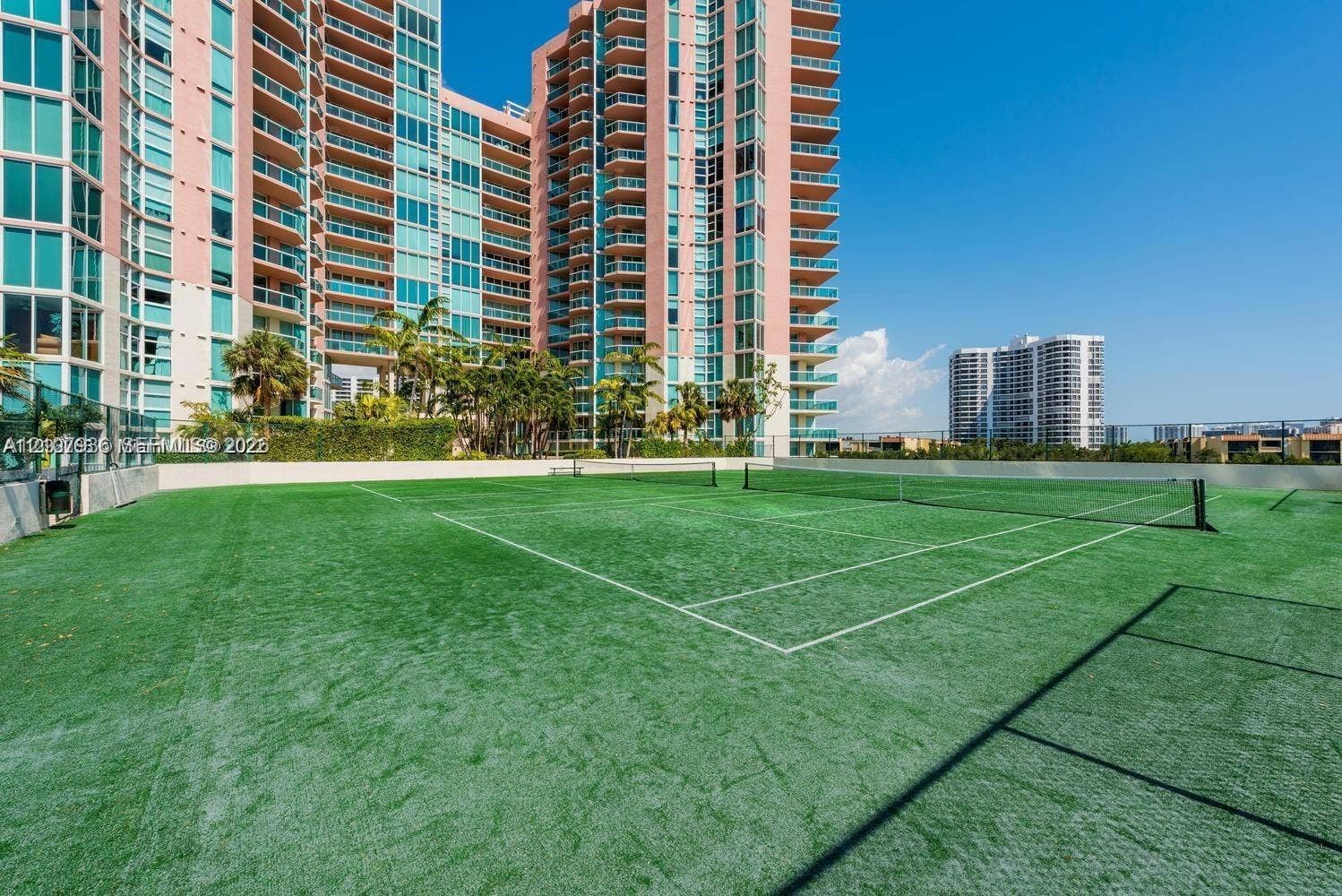 3370 Hidden Bay Drive, #510, Aventura, FL 33180 Outdoor tennis court featuring artificial turf surfacing, perimeter fencing, and net equipment