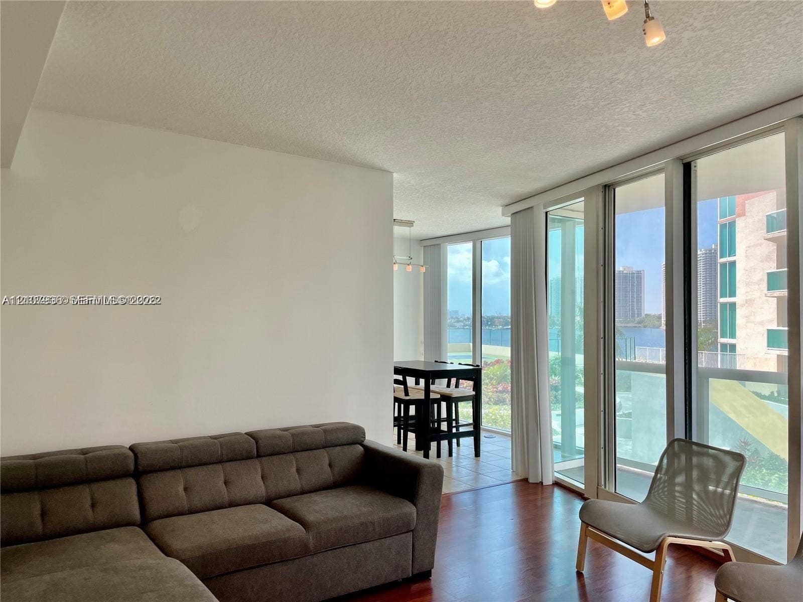 3370 Hidden Bay Drive, #510, Aventura, FL 33180 Floor-to-ceiling glass panel walls, wood-finish flooring, and recessed ceiling lighting