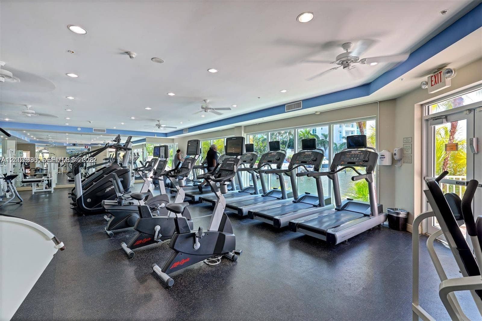 3370 Hidden Bay Drive, #510, Aventura, FL 33180 Fitness center featuring rubber flooring, recessed lighting, ceiling fans, mirrored walls, and floor-to-ceiling glass windows