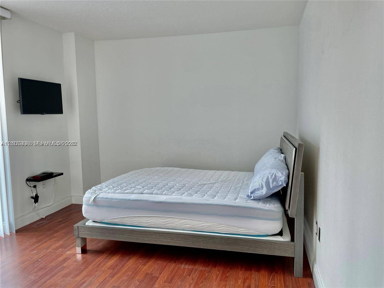 3370 Hidden Bay Drive, #510, Aventura, FL 33180 Room featuring wood-finish flooring and wall-mounted shelving