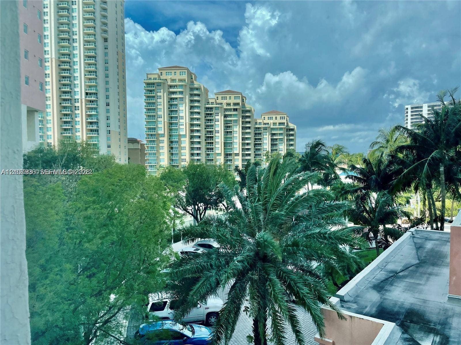 3370 Hidden Bay Drive, #510, Aventura, FL 33180 Elevated perspective featuring mature palm trees, dense foliage, and multi-story high-rise architecture