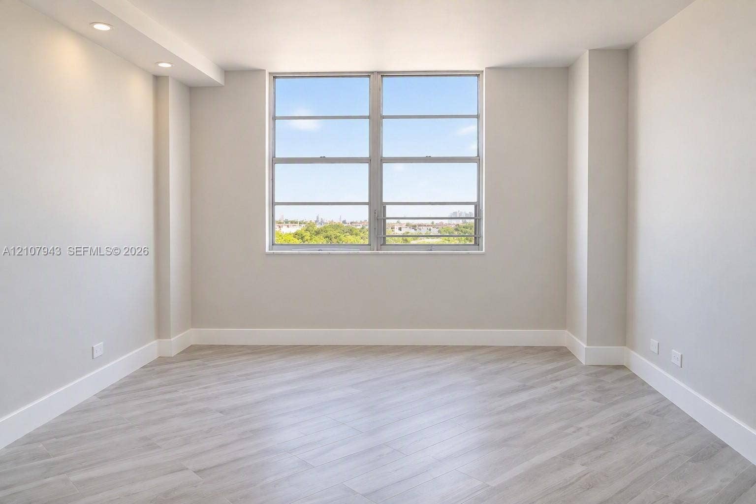 251 174th Street, #201, Sunny Isles Beach, Sunny Isles Beach, FL 33160 Neutral walls, wood-finish flooring, recessed lighting, and large picture window with outdoor scenery