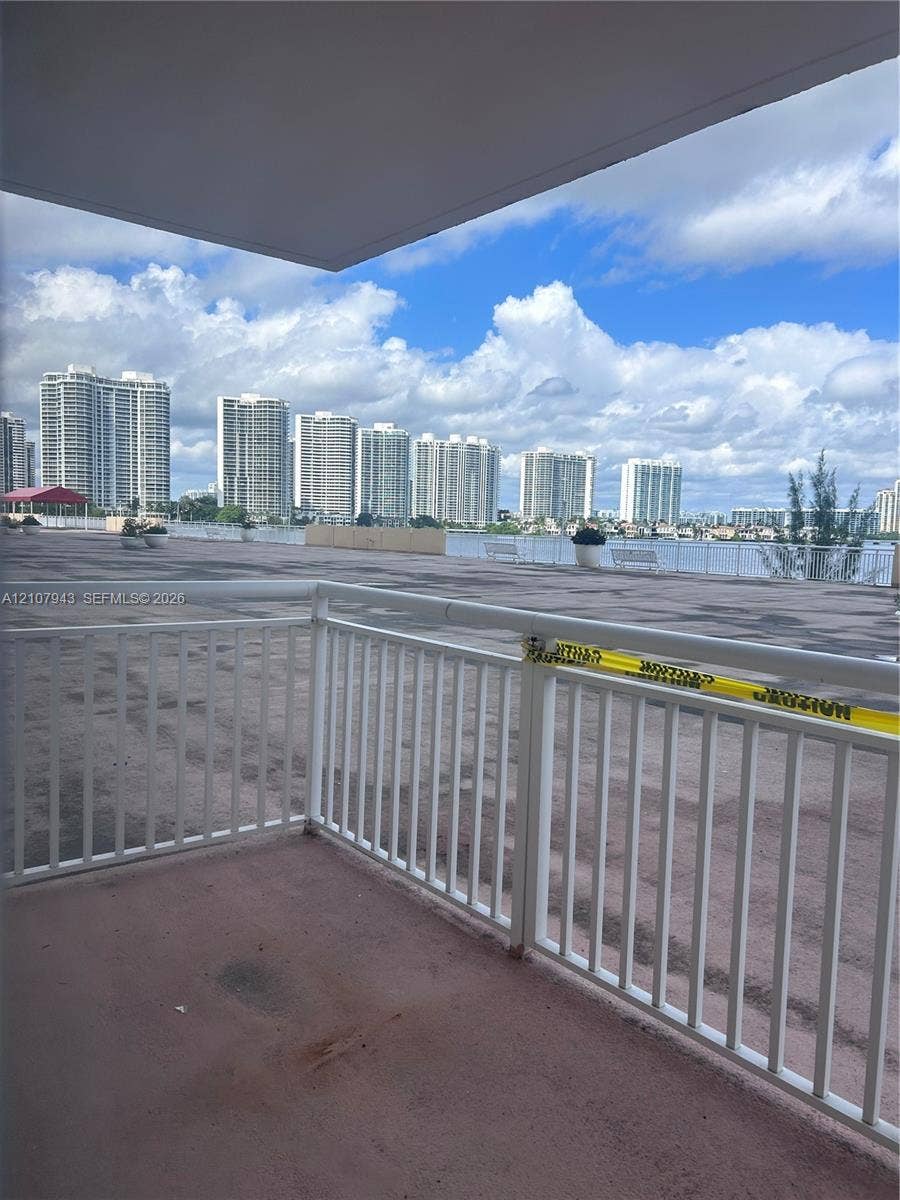 251 174th Street, #201, Sunny Isles Beach, Sunny Isles Beach, FL 33160 Covered balcony featuring white metal railings and expansive outdoor space