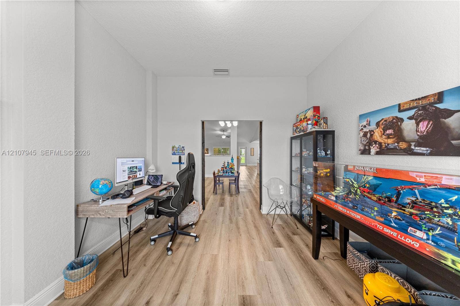 Neutral-toned interior featuring wood-finish flooring and a rectangular entryway