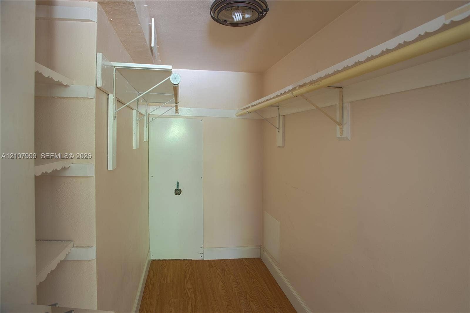 4200 Crystal Lake Drive, #204, Deerfield Beach, Deerfield Beach, FL 33064 Storage space featuring wood-finish flooring, white shelving units, a hanging rod, and a ceiling-mounted light fixture