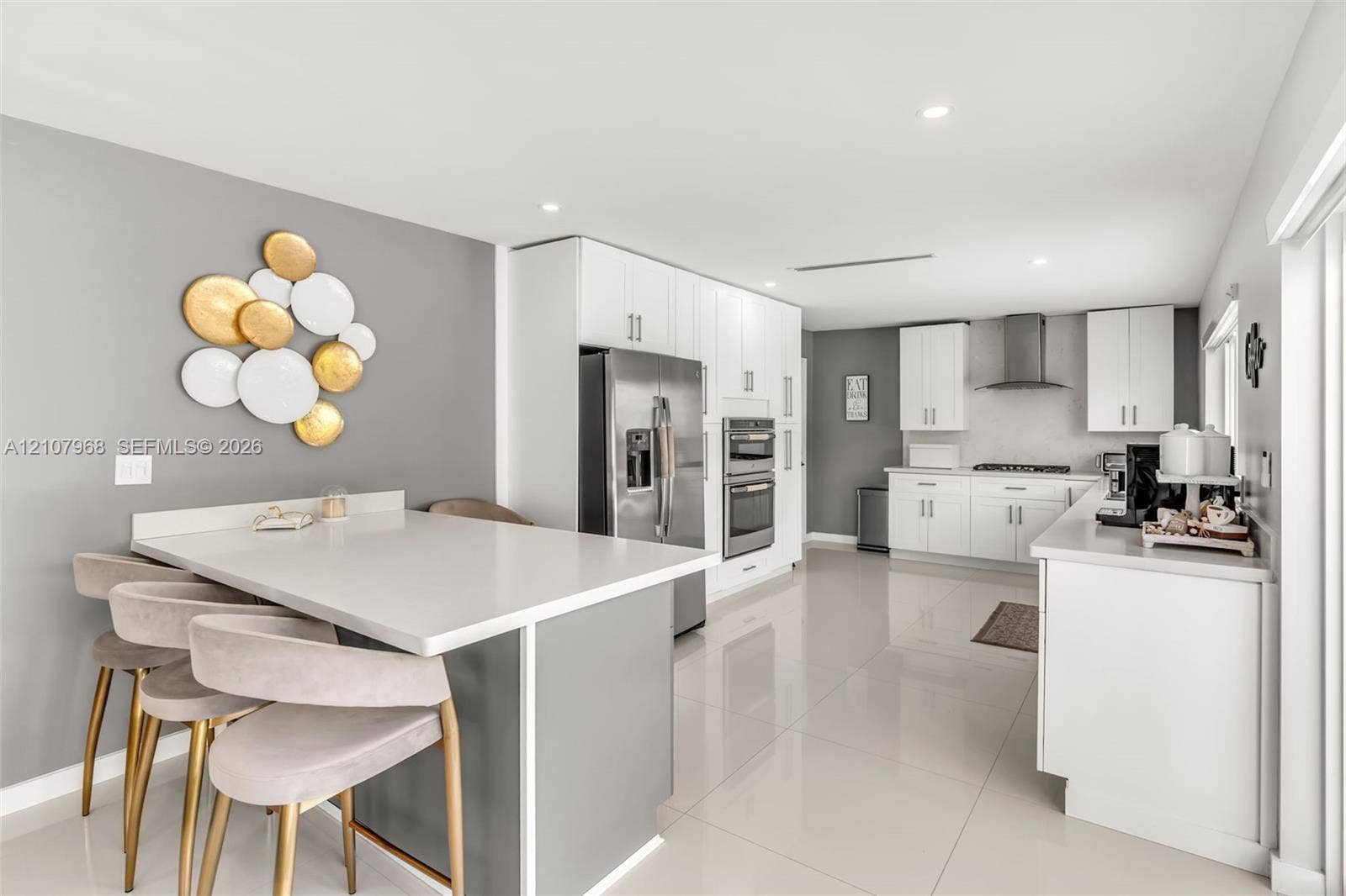10841 SW 126th Street, Miami, FL 33176 Kitchen featuring white shaker-style cabinetry, quartz countertops, stainless steel appliances, recessed lighting, and large-format porcelain tile flooring