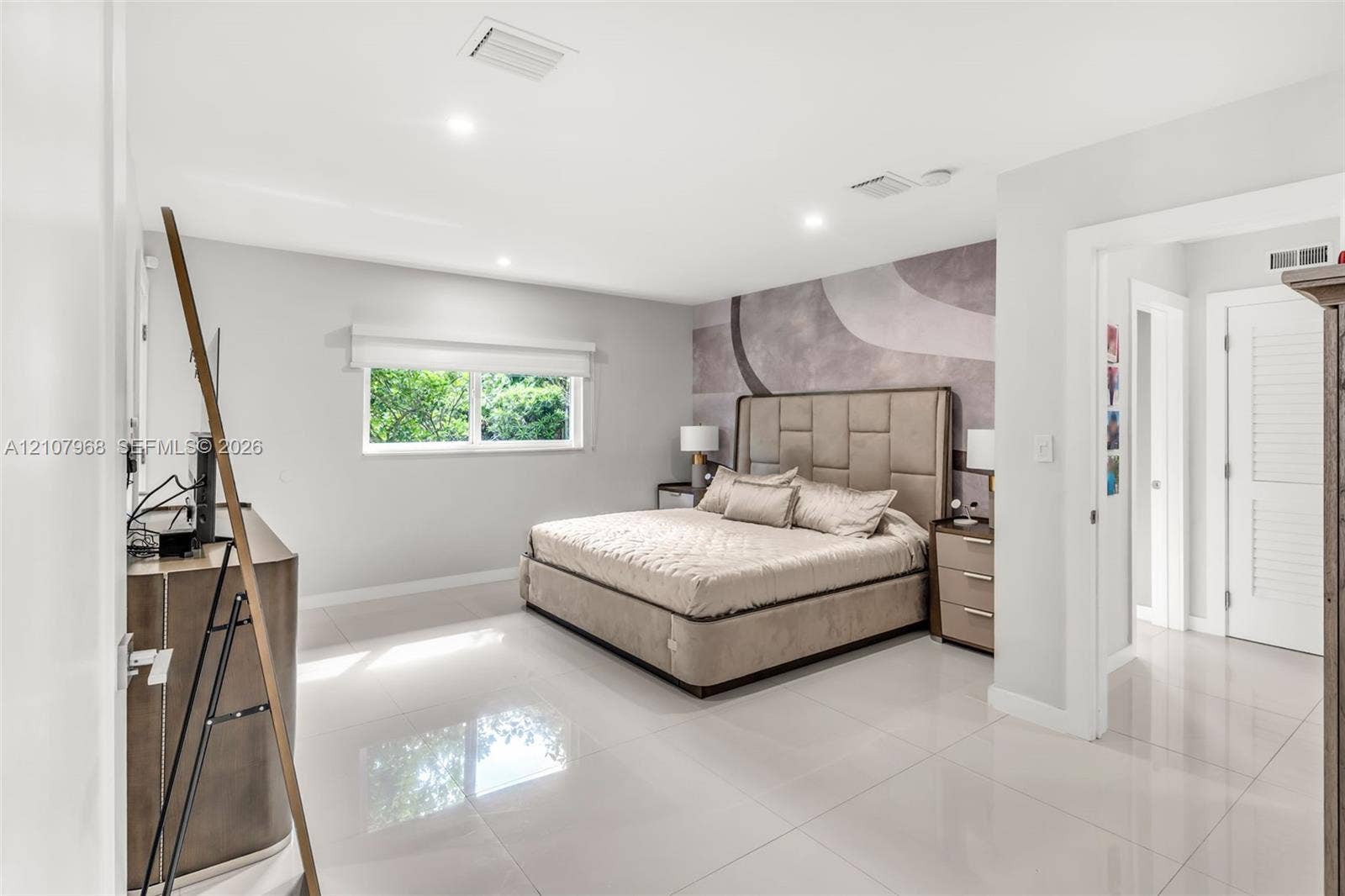 10841 SW 126th Street, Miami, FL 33176 Spacious room featuring polished tile flooring, recessed lighting, and a large-format textured accent wall