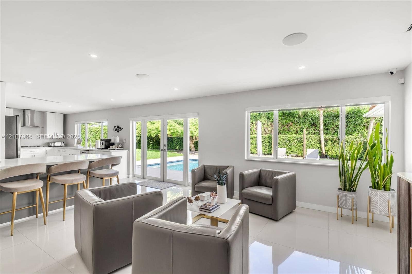 10841 SW 126th Street, Miami, FL 33176 Open-concept interior featuring large-format tile flooring, recessed lighting, and a kitchen island with quartz-style countertop