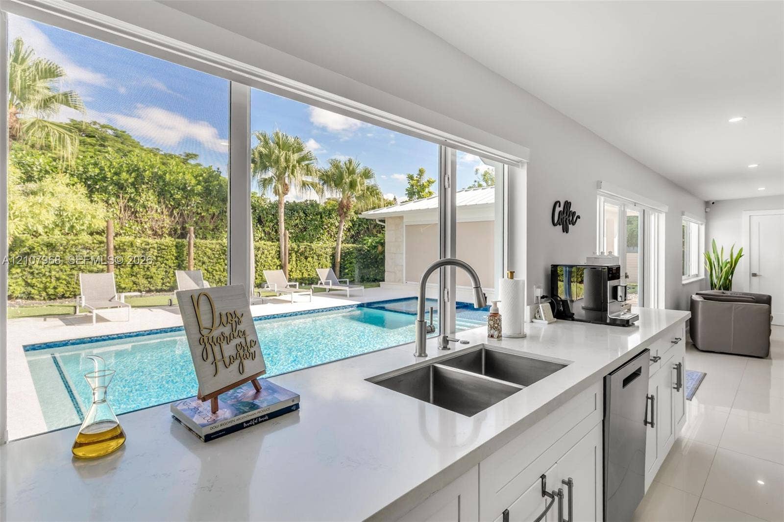 10841 SW 126th Street, Miami, FL 33176 Kitchen featuring expansive windows, white cabinetry, quartz countertops, dual-basin stainless steel sink, and stainless steel dishwasher