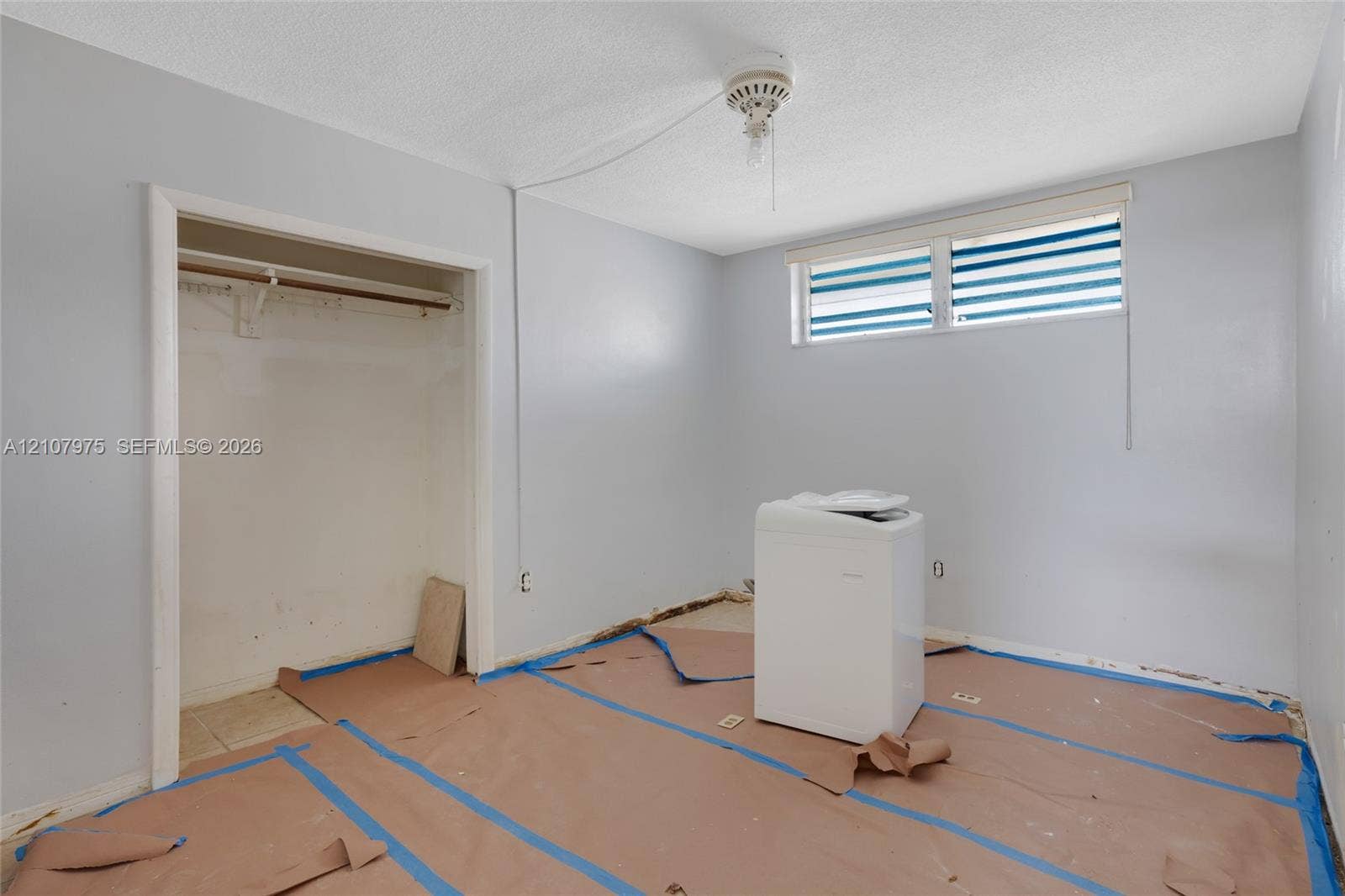 2910 Point East Drive, #M108, Aventura, FL 33160 Interior space featuring a reach-in closet with a built-in rod and a high-set horizontal window
