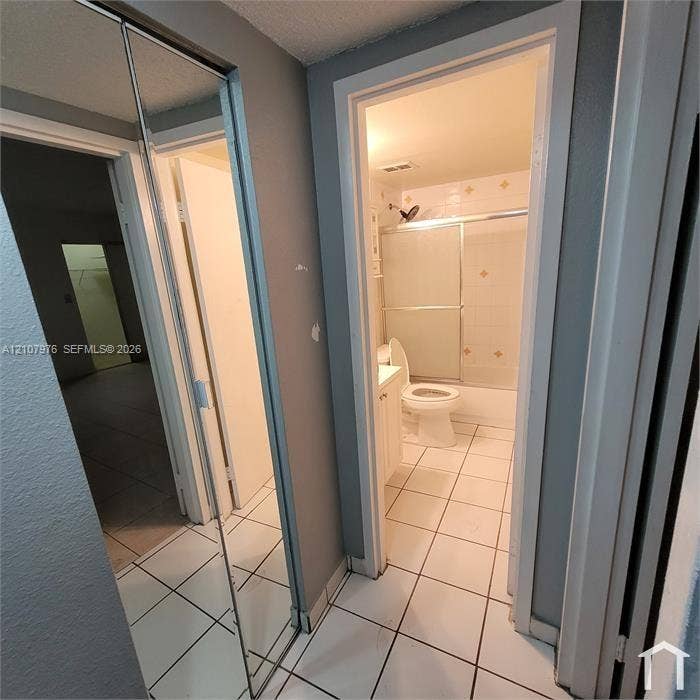 5100 SW 41st Street, #101, Hollywood, Hollywood, FL 33023 Full-height mirrored sliding closet doors and white ceramic tile flooring
