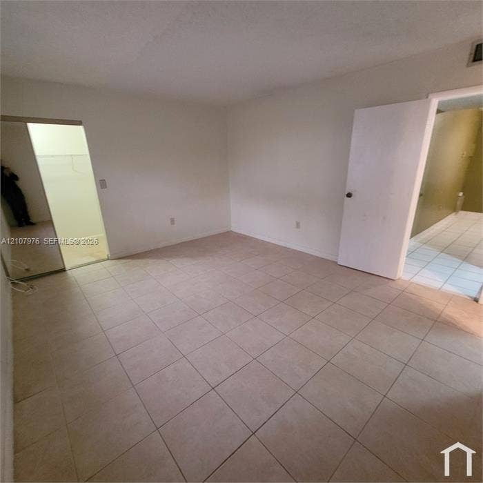 5100 SW 41st Street, #101, Hollywood, Hollywood, FL 33023 Kitchen featuring white cabinetry, stainless steel appliances, ceramic tile flooring, and a tiled backsplash with decorative accents