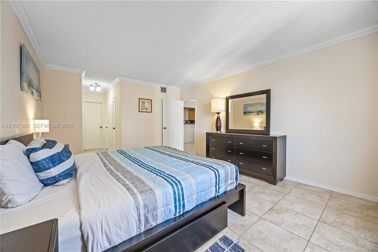 3725 S Ocean Drive, #1120, Hollywood, Hollywood, FL 33019 Neutral-toned walls with crown molding, light-colored tile flooring, and solid-core doors