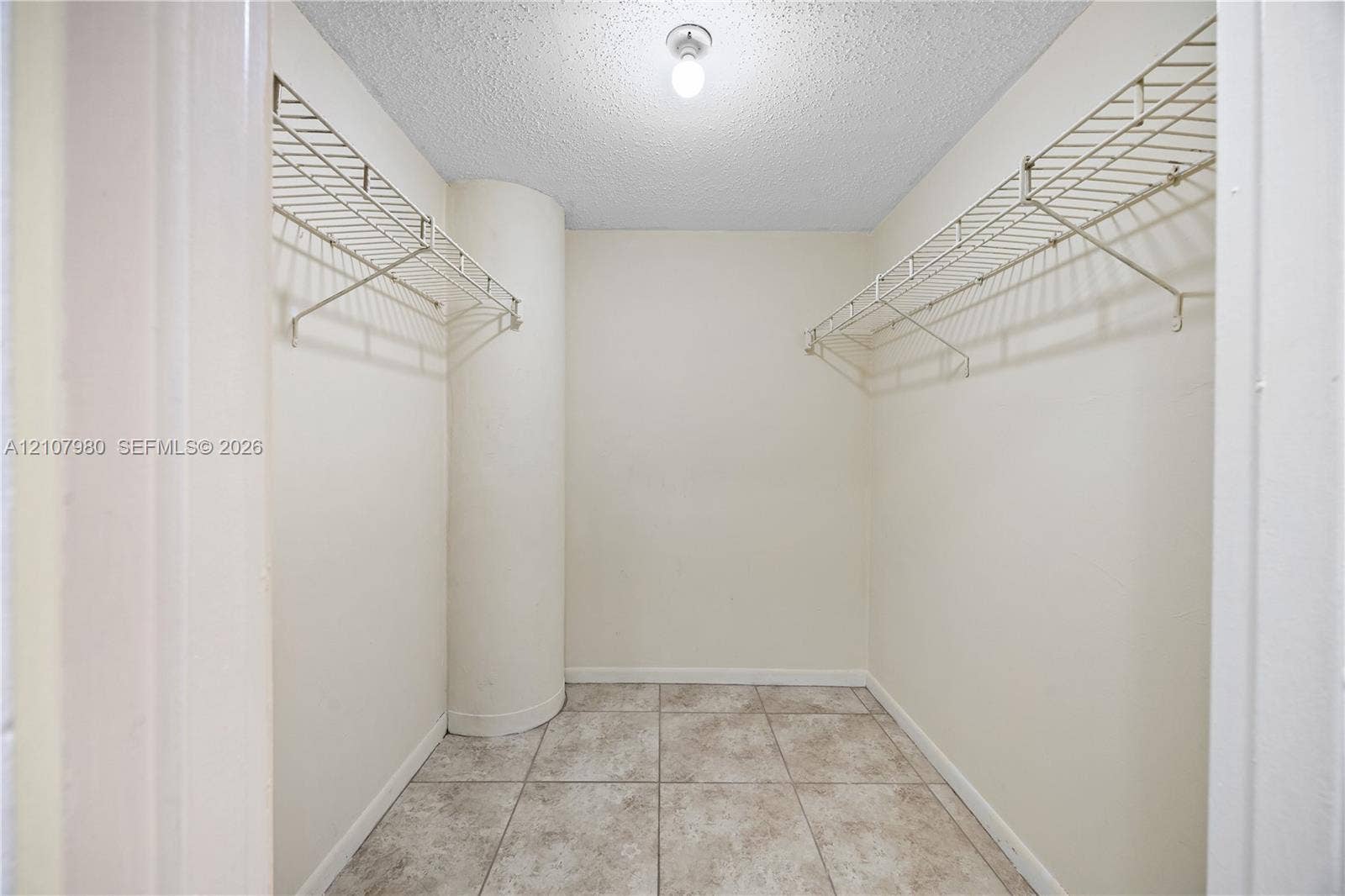 3725 S Ocean Drive, #1120, Hollywood, Hollywood, FL 33019 Storage area featuring tile flooring, dual-level wire shelving, and a singular ceiling-mounted light fixture