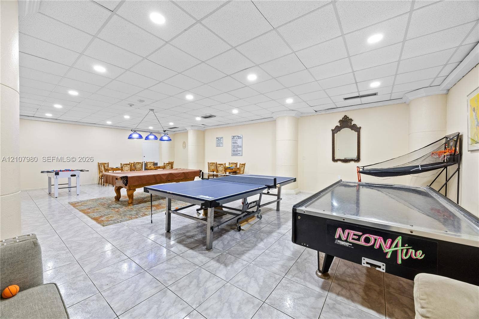3725 S Ocean Drive, #1120, Hollywood, Hollywood, FL 33019 Spacious room featuring neutral wall tones, large-format tile flooring, recessed ceiling lighting, and a drop ceiling grid
