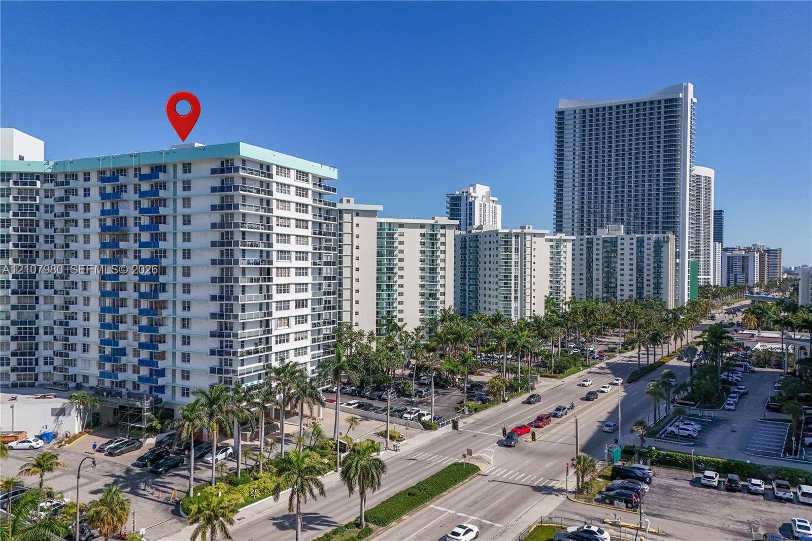 3725 S Ocean Drive, #1120, Hollywood, Hollywood, FL 33019 High-rise residential exterior featuring private balconies, integrated concrete construction, and mature palm tree landscaping