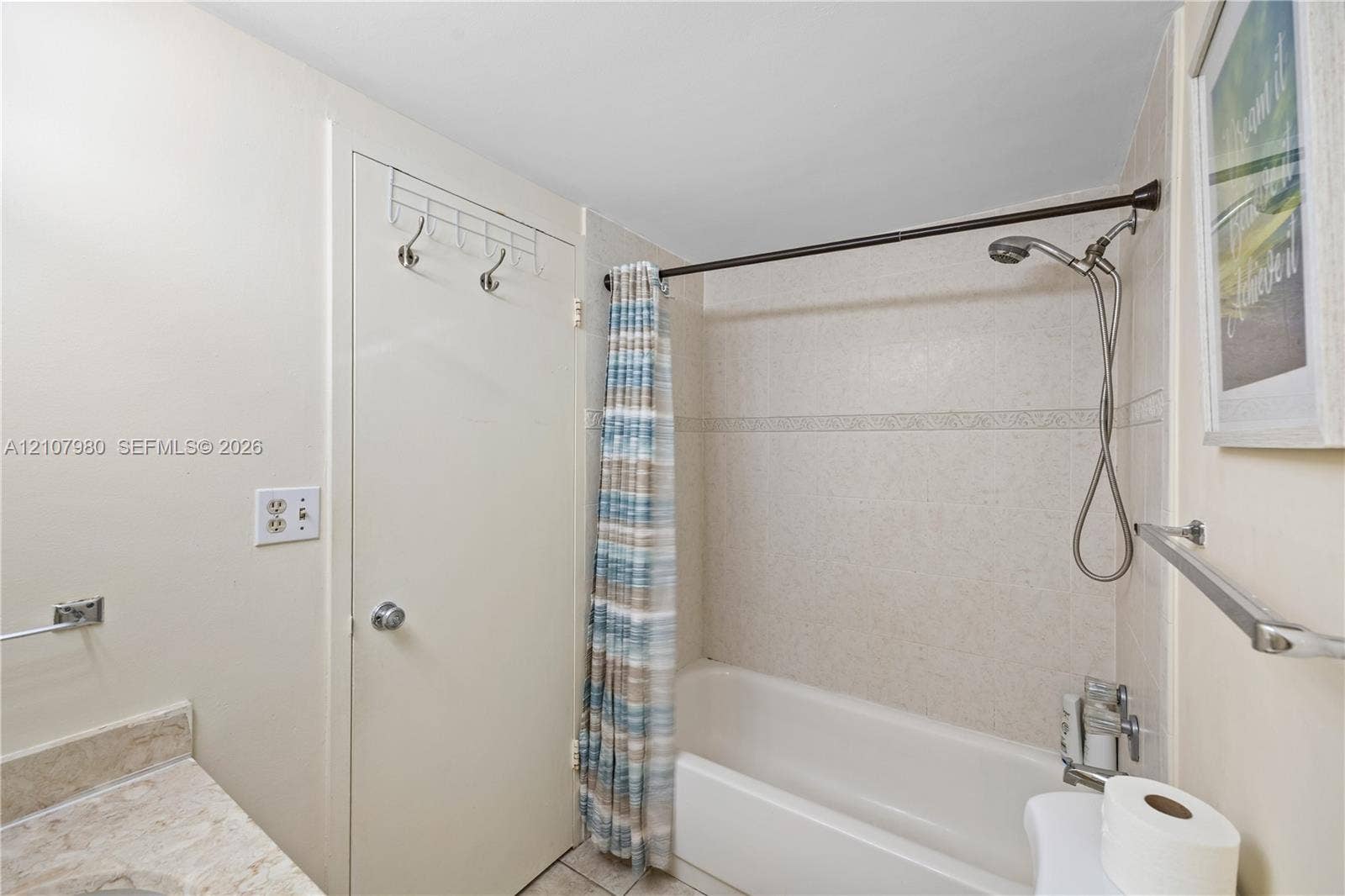 3725 S Ocean Drive, #1120, Hollywood, Hollywood, FL 33019 Bathroom featuring a tiled tub surround, a shower system with an adjustable handheld sprayer, and a stone-surface vanity countertop