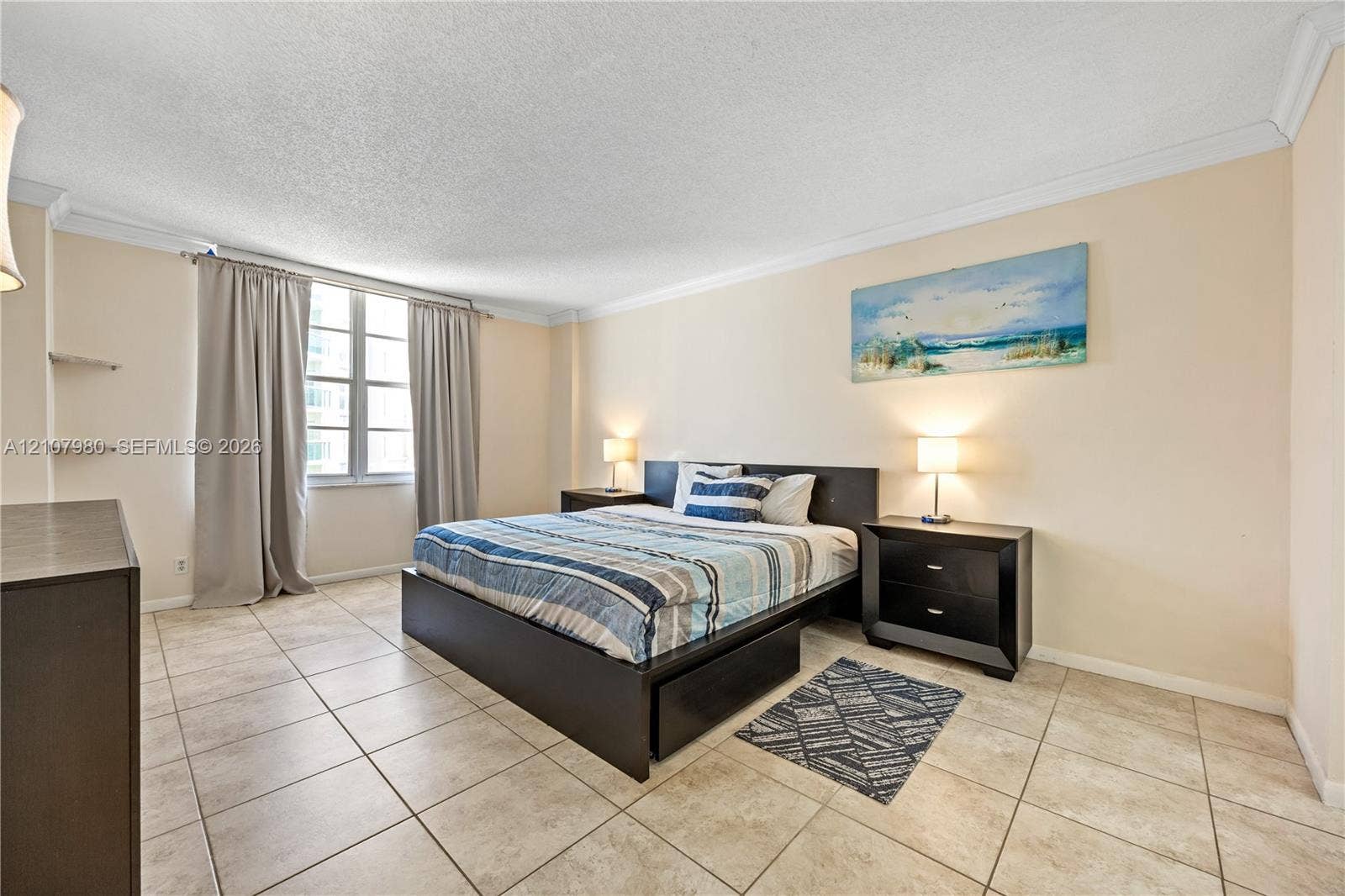3725 S Ocean Drive, #1120, Hollywood, Hollywood, FL 33019 Neutral-toned ceramic tile flooring, multi-panel window, crown molding, and built-in wall shelving