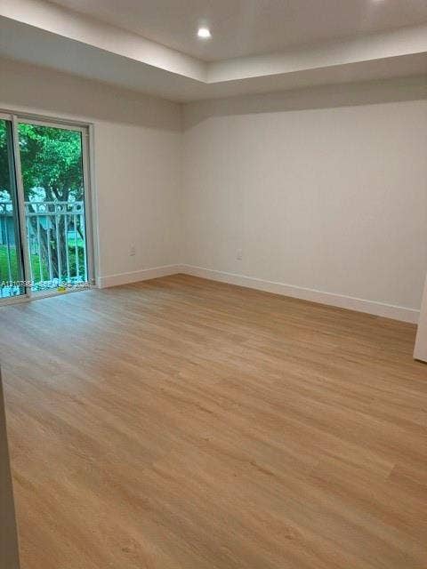 1567 NW 94th Way, #10, Coral Springs, Coral Springs, FL 33071 Interior room featuring wood-finish flooring, a tray ceiling, recessed lighting, and a sliding glass door with exterior balcony railing