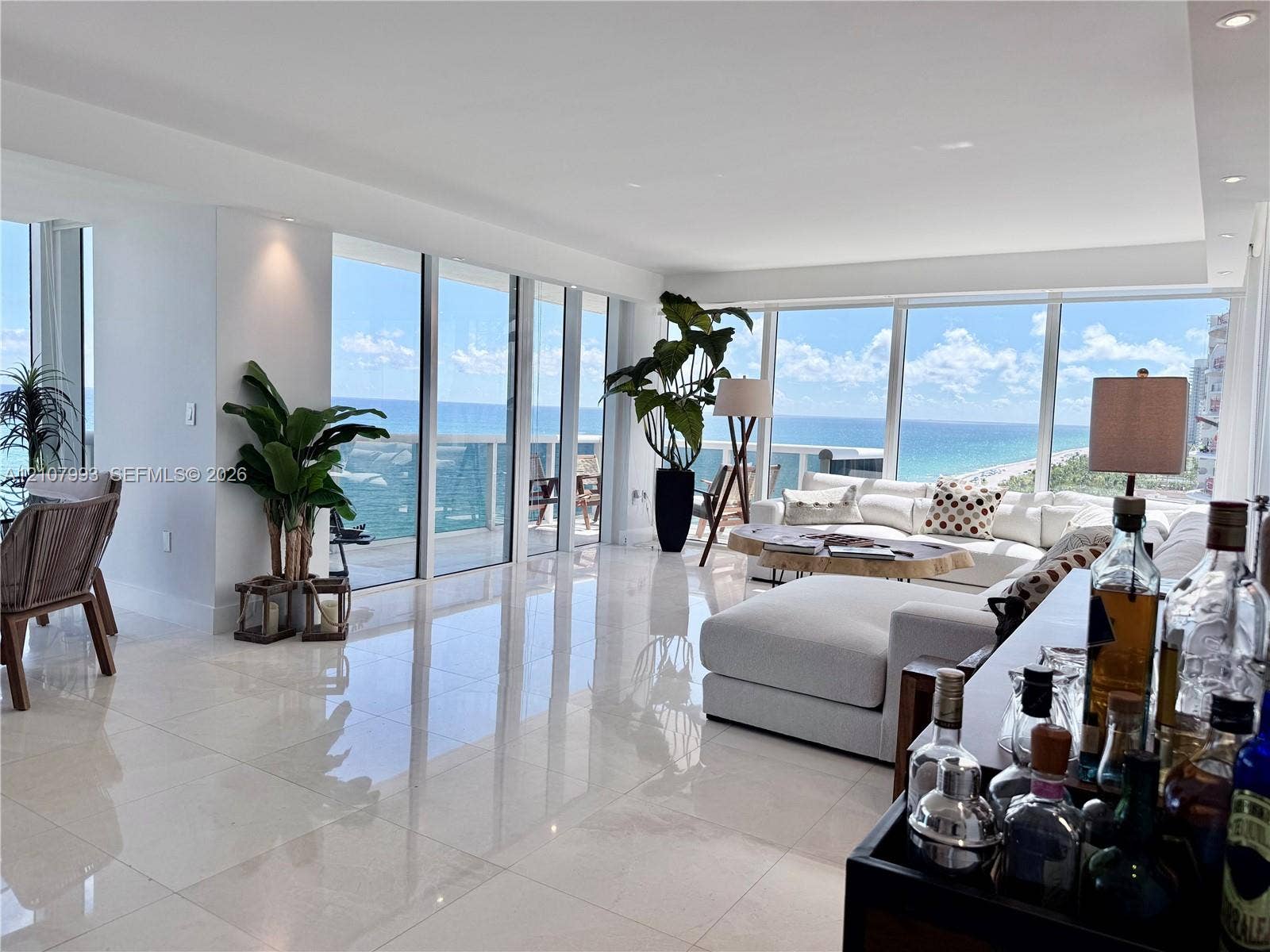 10275 Collins Avenue, #1110, Bal Harbour, Bal Harbour, FL 33154 Open-concept interior featuring floor-to-ceiling glass paneling, polished stone-finish tile flooring, recessed ceiling lighting, and a private balcony