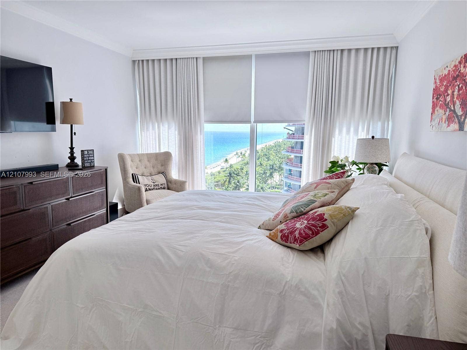 10275 Collins Avenue, #1110, Bal Harbour, Bal Harbour, FL 33154 Floor-to-ceiling windows featuring coastal scenery, crown molding, and neutral wall-to-wall carpeting