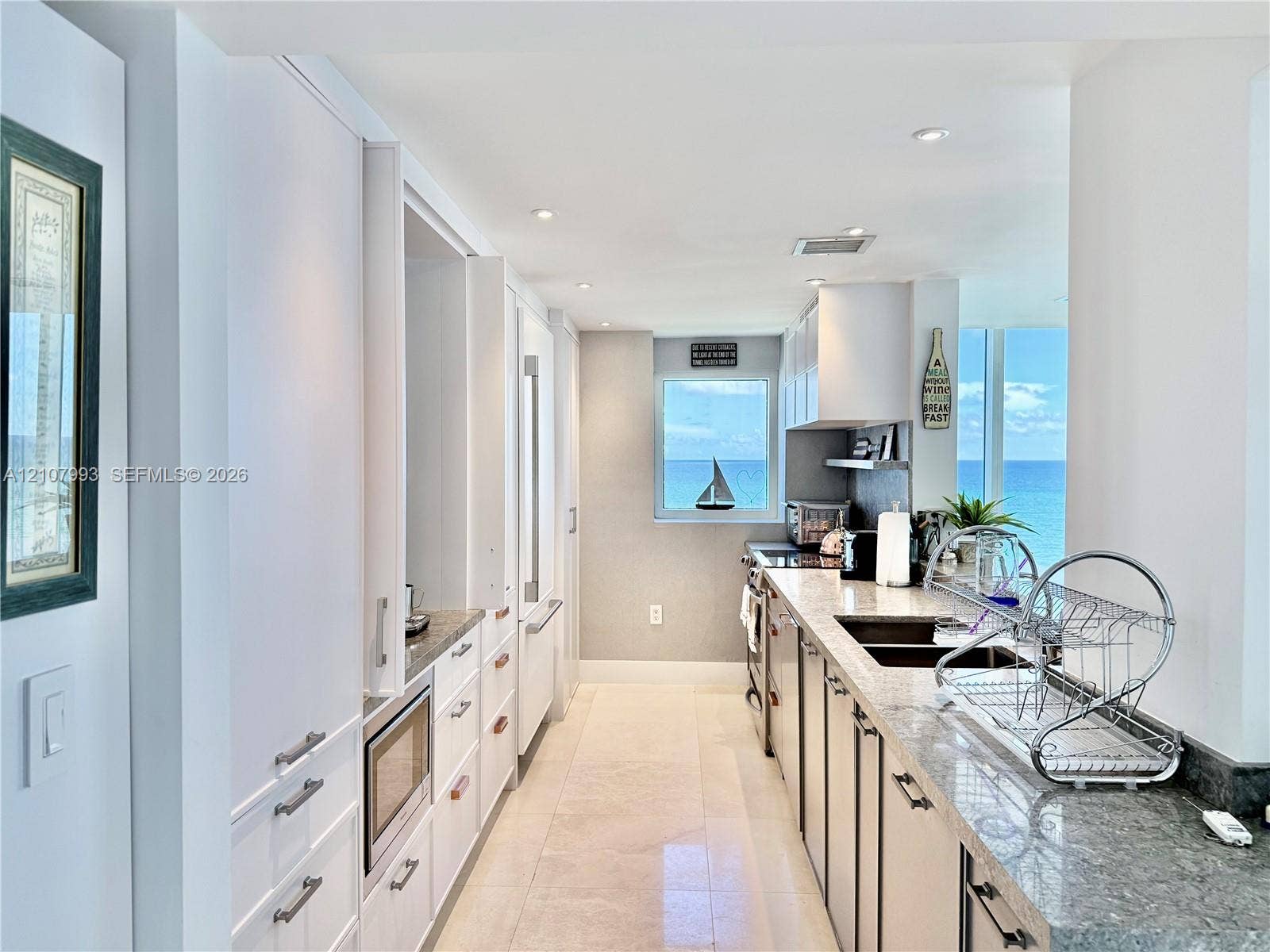 10275 Collins Avenue, #1110, Bal Harbour, Bal Harbour, FL 33154 Kitchen featuring flat-panel white cabinetry, stone-surface countertops, recessed lighting, and large windows with ocean scenery