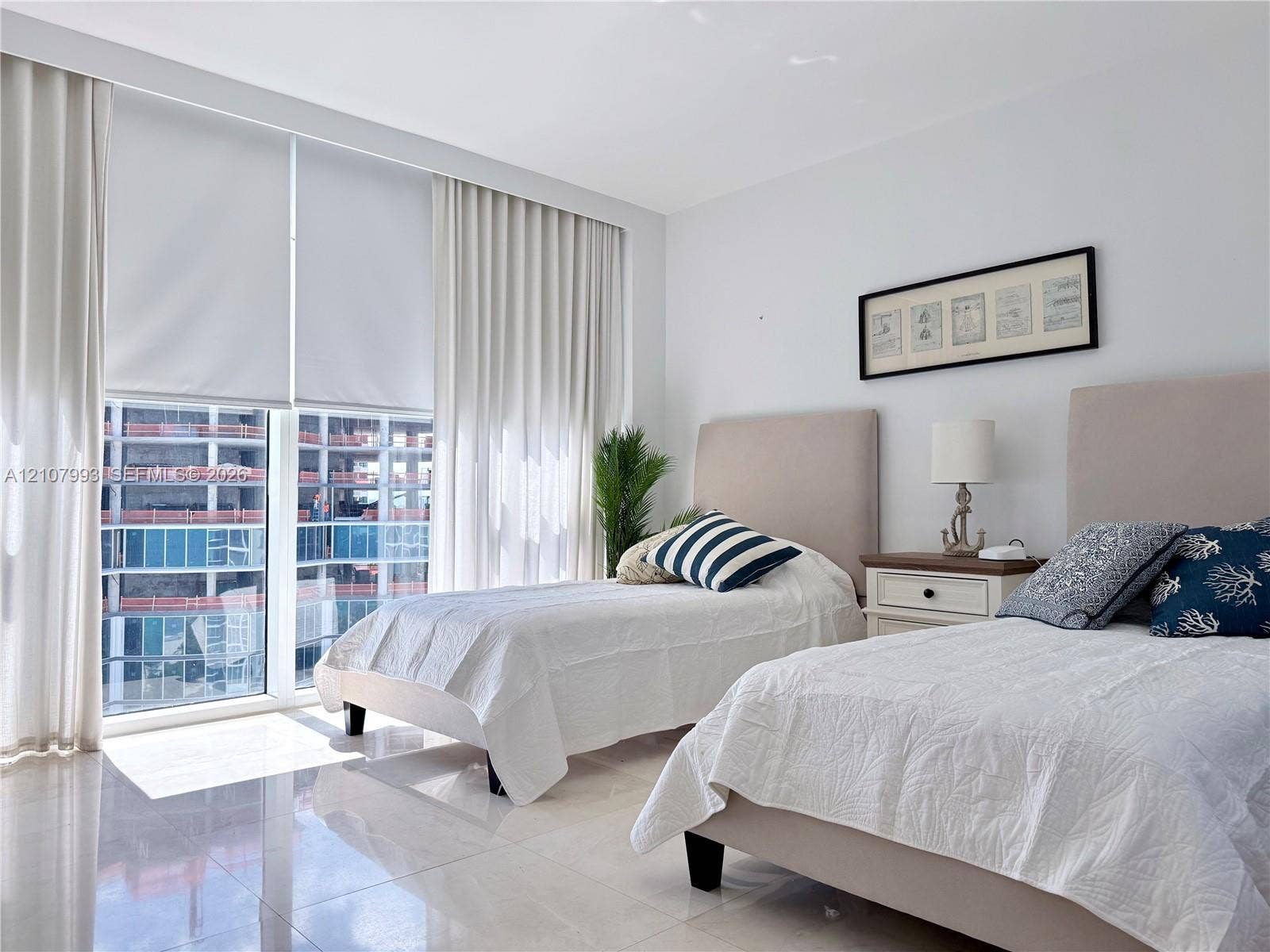 10275 Collins Avenue, #1110, Bal Harbour, Bal Harbour, FL 33154 Floor-to-ceiling windows featuring automated roller shades, complemented by polished tile flooring and neutral wall finishes