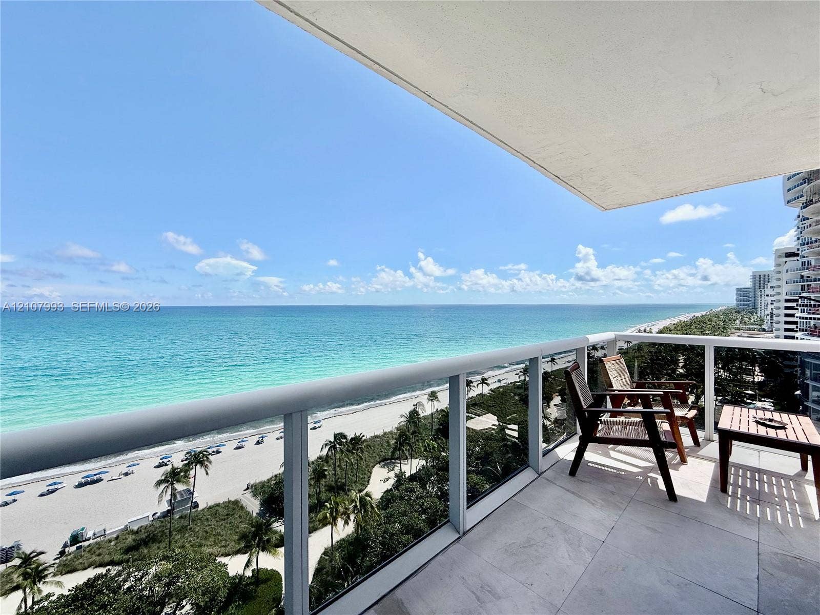 10275 Collins Avenue, #1110, Bal Harbour, Bal Harbour, FL 33154 Private balcony featuring large-format tile flooring and a glass panel railing with a metallic frame