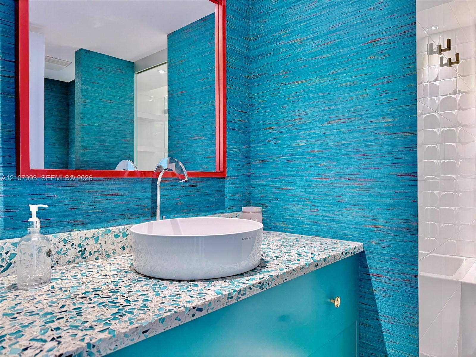 10275 Collins Avenue, #1110, Bal Harbour, Bal Harbour, FL 33154 Custom vanity featuring a speckled composite countertop, a circular vessel sink, a high-arc chrome faucet, and textured wall coverings