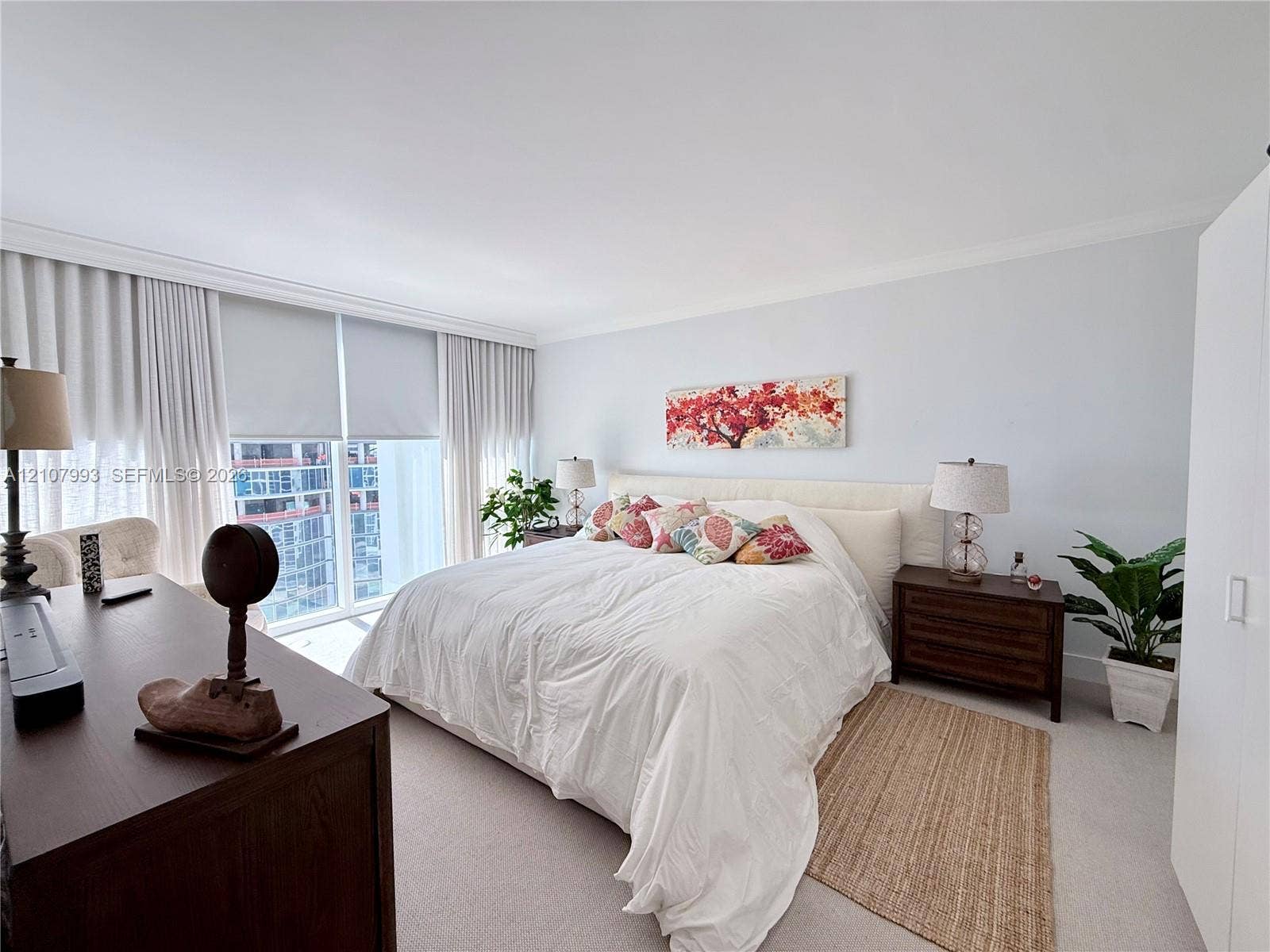 10275 Collins Avenue, #1110, Bal Harbour, Bal Harbour, FL 33154 Floor-to-ceiling windows featuring automated roller shades, neutral carpeting, and crown molding