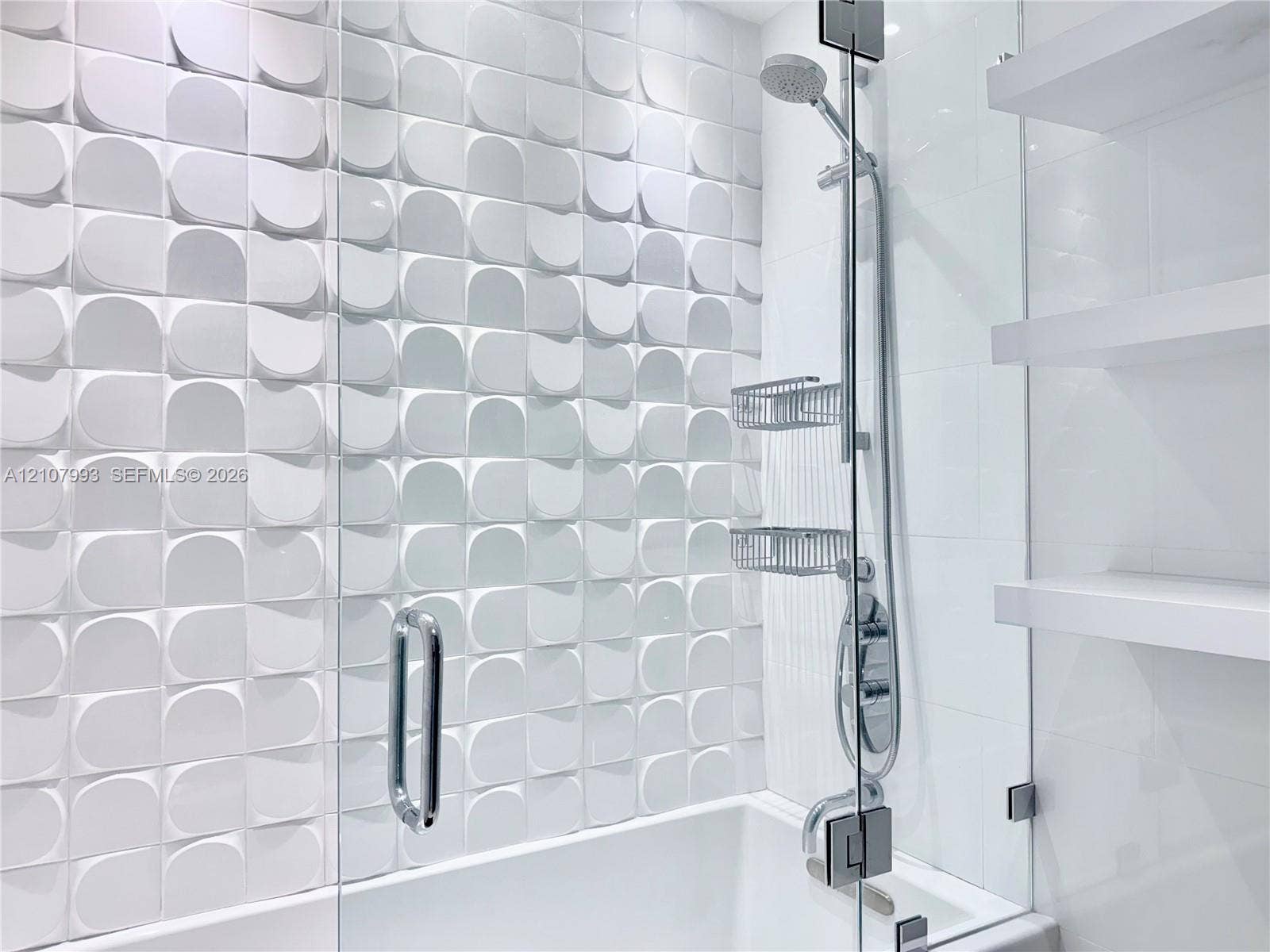 10275 Collins Avenue, #1110, Bal Harbour, Bal Harbour, FL 33154 Textured three-dimensional wall tile, glass-enclosed shower, adjustable height handheld shower head, and built-in floating shelves
