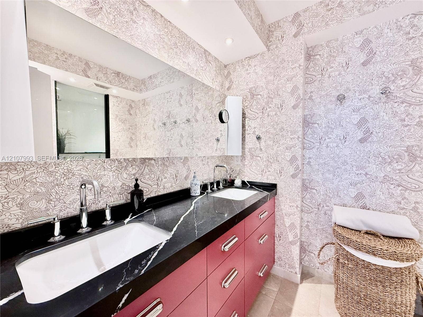 10275 Collins Avenue, #1110, Bal Harbour, Bal Harbour, FL 33154 Custom vanity with matte-finish cabinetry, dark stone countertop with white veining, dual under-mount sinks, chrome widespread faucets, and wall-to-wall mirror