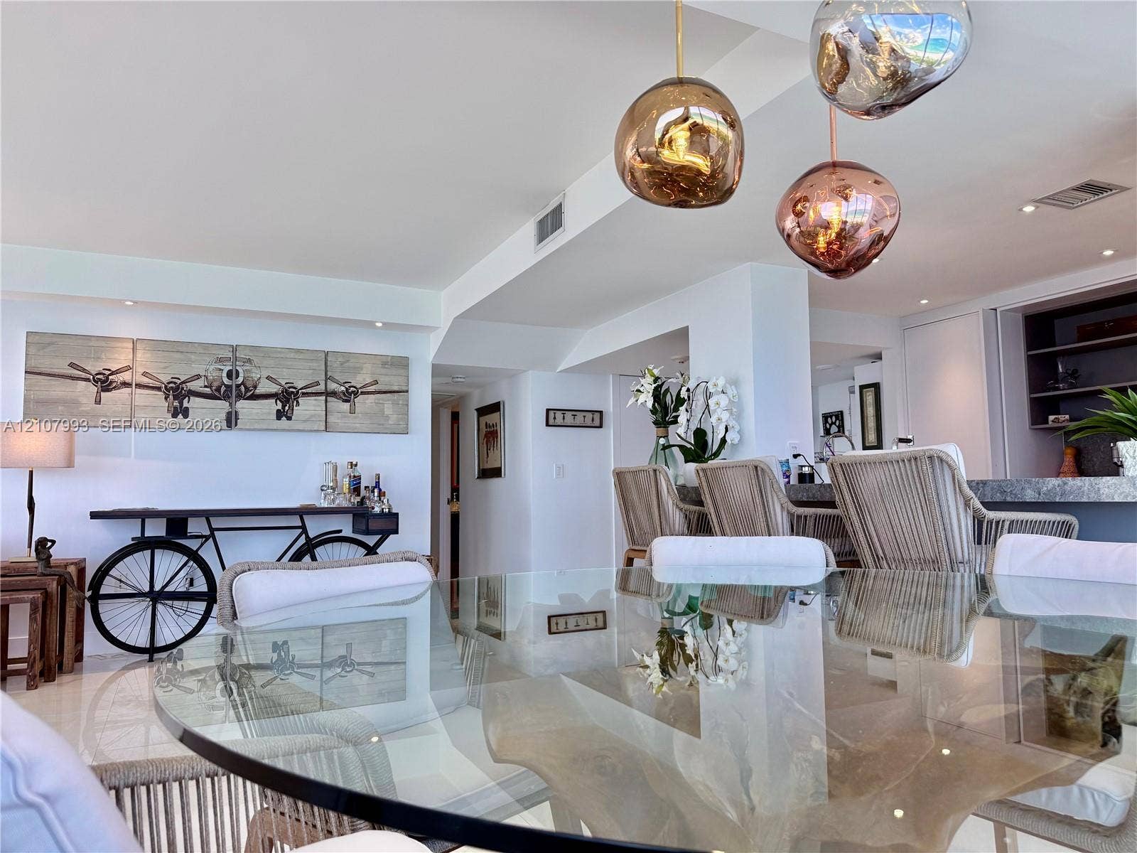 10275 Collins Avenue, #1110, Bal Harbour, Bal Harbour, FL 33154 Open-concept space featuring metallic pendant light fixtures, polished stone flooring, and built-in shelving