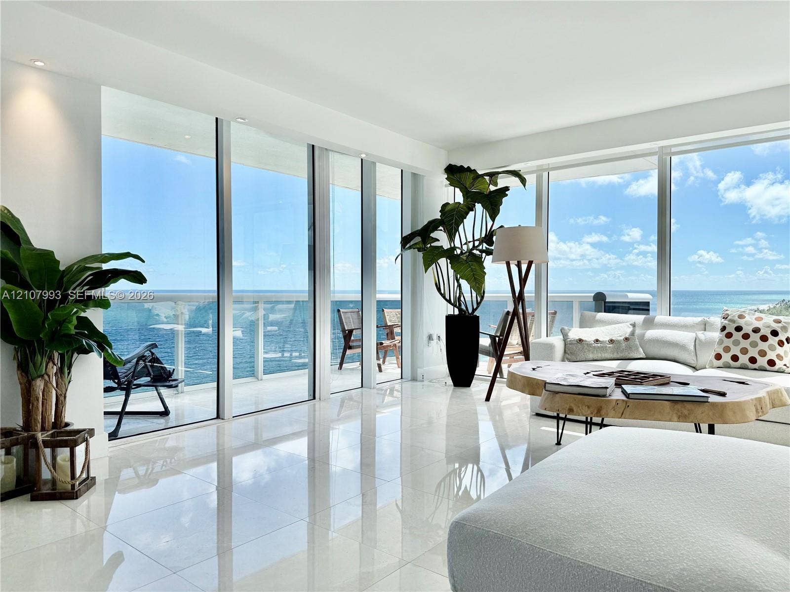 10275 Collins Avenue, #1110, Bal Harbour, Bal Harbour, FL 33154 Floor-to-ceiling glass walls, polished stone flooring, recessed lighting, and a glass-railed balcony overlooking the ocean