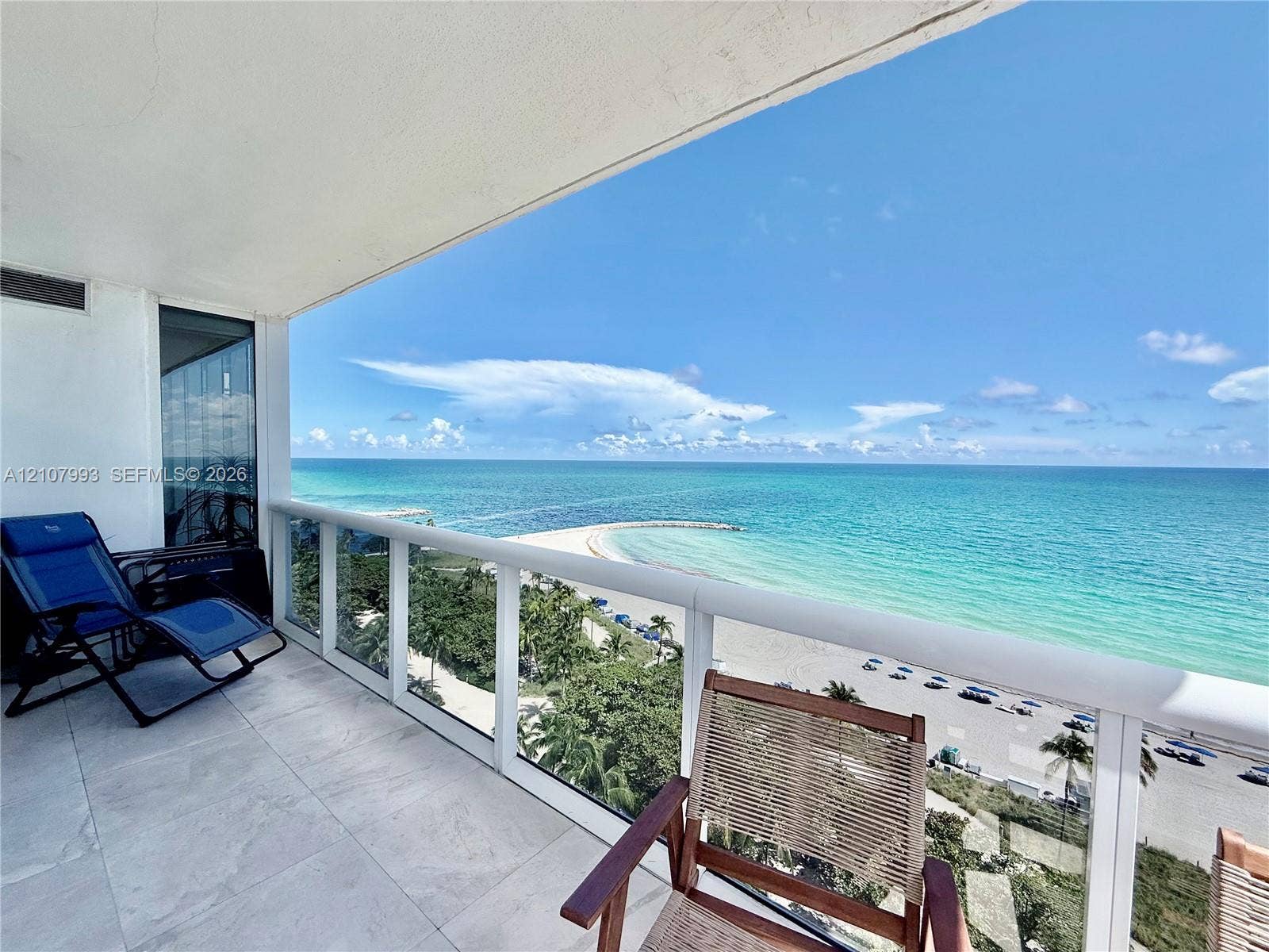10275 Collins Avenue, #1110, Bal Harbour, Bal Harbour, FL 33154 Covered balcony featuring large-format stone flooring and glass panel railing