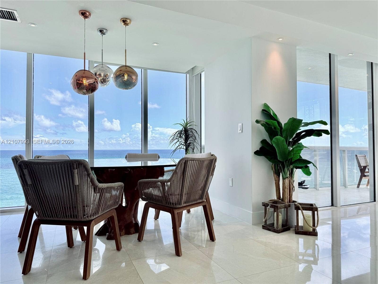 10275 Collins Avenue, #1110, Bal Harbour, Bal Harbour, FL 33154 Floor-to-ceiling windows, polished tile flooring, and metallic spherical pendant lighting