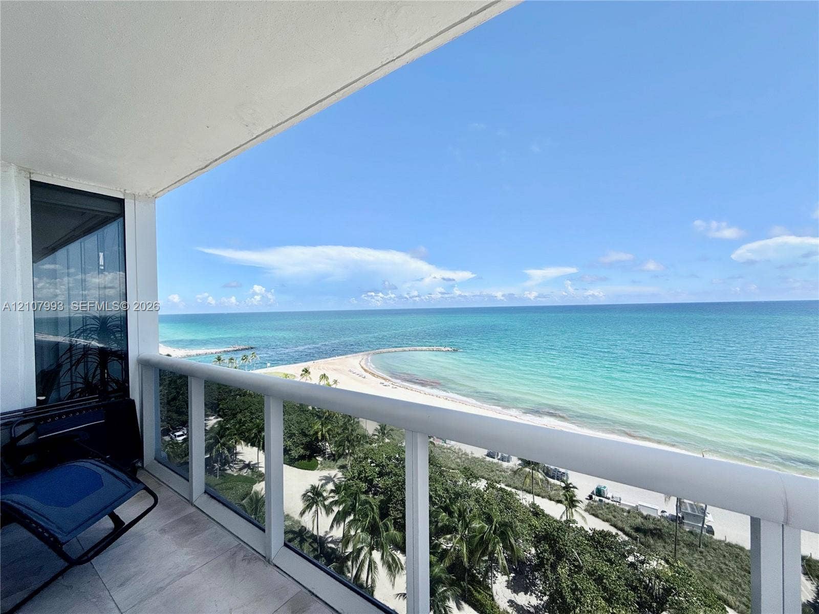 10275 Collins Avenue, #1110, Bal Harbour, Bal Harbour, FL 33154 Covered balcony featuring glass-panel railings, tile flooring, and direct oceanfront scenery