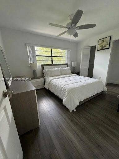 6814 SW 114th Place, #G65, Miami, FL 33173 Second bedroom featuring wood-finish flooring, and floor-to-ceiling louvered closet doors. Bed linens virtually stages