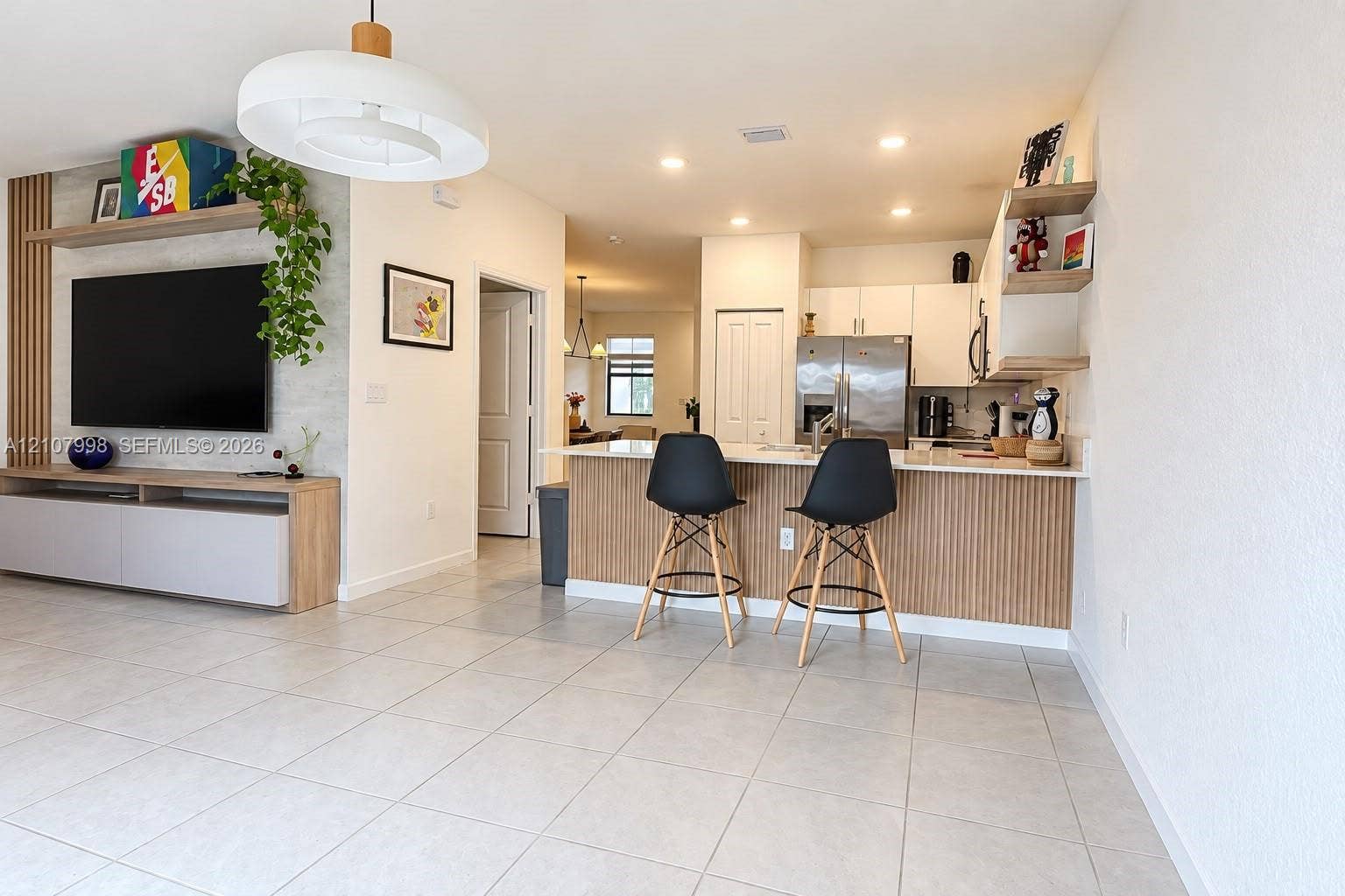 23471 SW 129th Avenue, Homestead, Homestead, FL 33032 Kitchen featuring white cabinetry, a built-in wood-slat peninsula, integrated floating shelving, and tile flooring