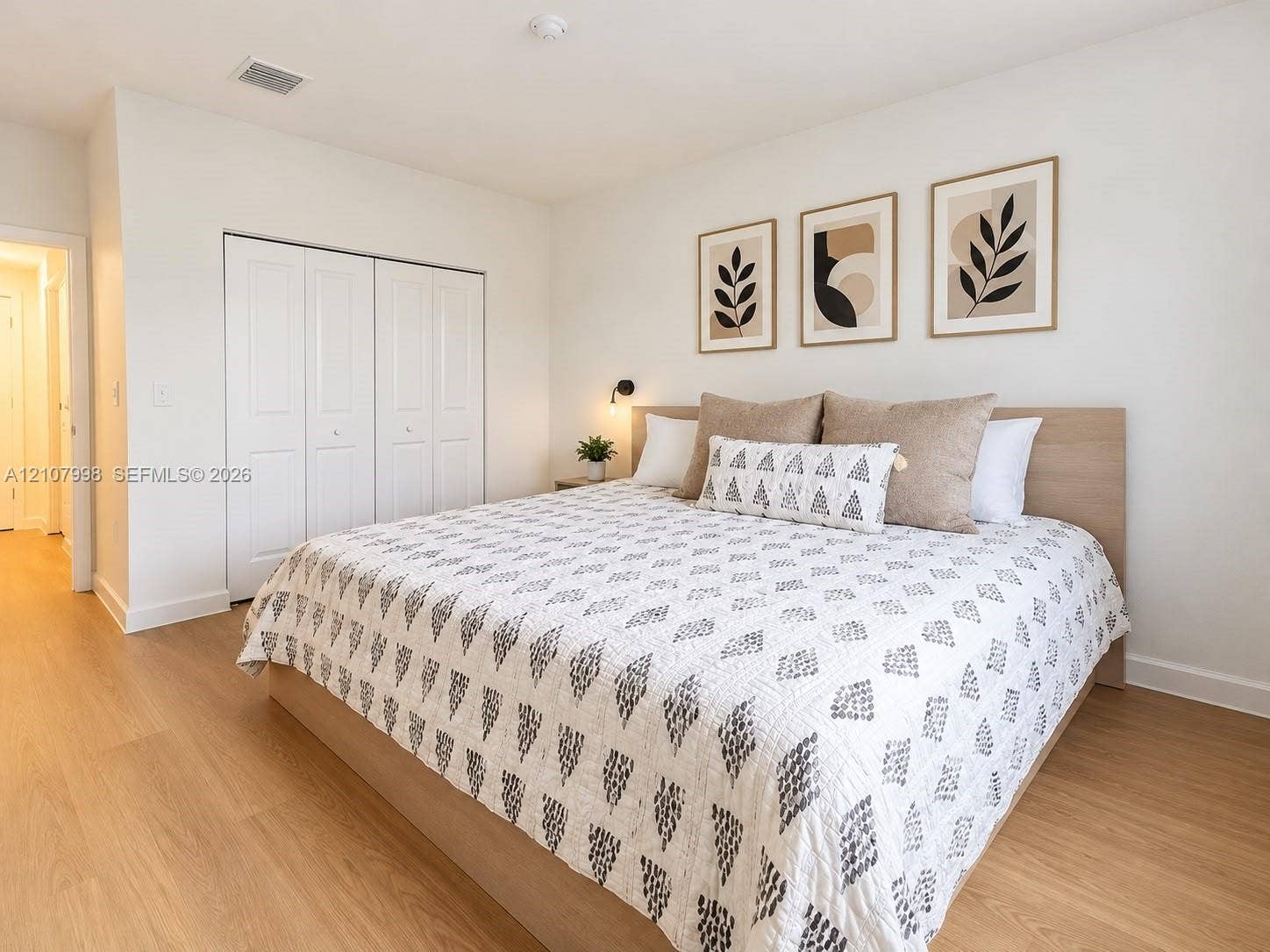 23471 SW 129th Avenue, Homestead, Homestead, FL 33032 Neutral wall tones, wood-finish flooring, and built-in closet with multi-panel doors