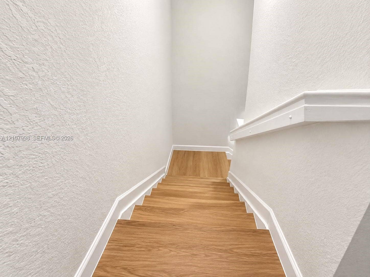23471 SW 129th Avenue, Homestead, Homestead, FL 33032 Staircase featuring wood-finish treads and a white painted handrail