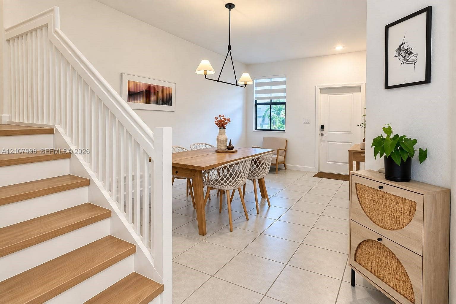 23471 SW 129th Avenue, Homestead, Homestead, FL 33032 Staircase with wood-finish treads and white balusters, ceramic tile flooring, modern geometric pendant lighting, and neutral wall tones