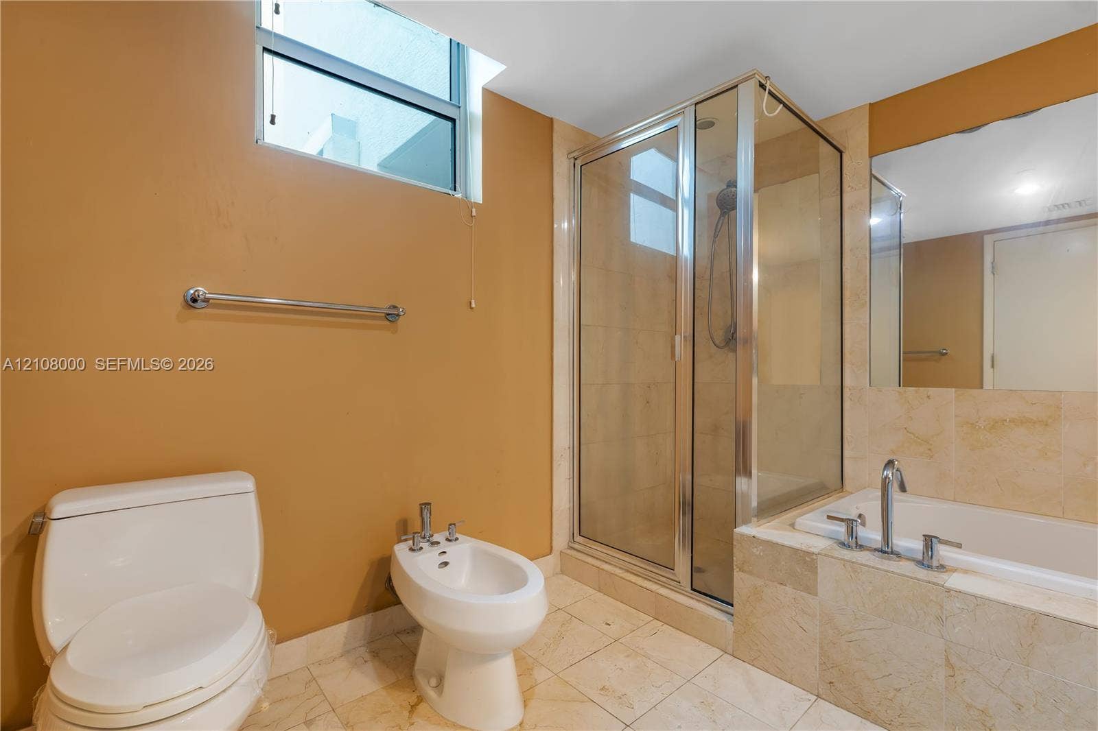 Aventura, FL 33180 Bathroom featuring a glass-enclosed shower, a deep-set soaking tub with stone tile surround, a bidet, and large-format tile flooring