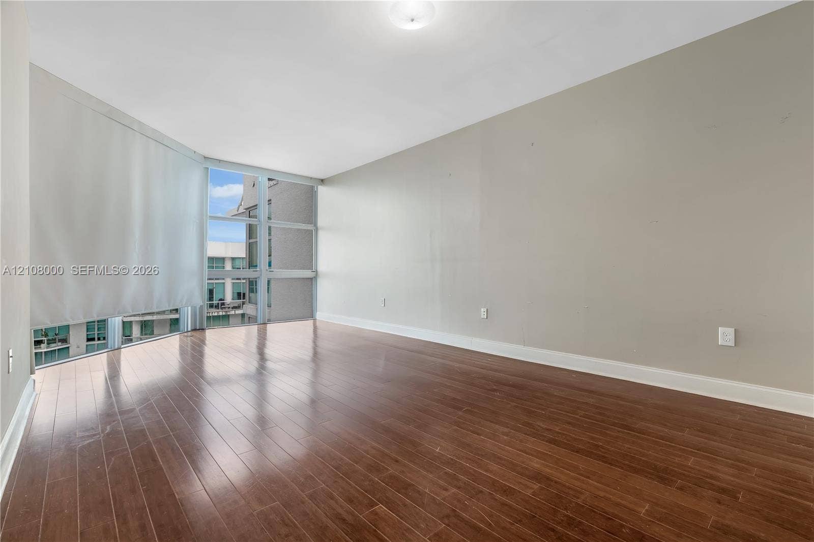 Aventura, FL 33180 Floor-to-ceiling windows, wood-finish flooring, and recessed ceiling lighting