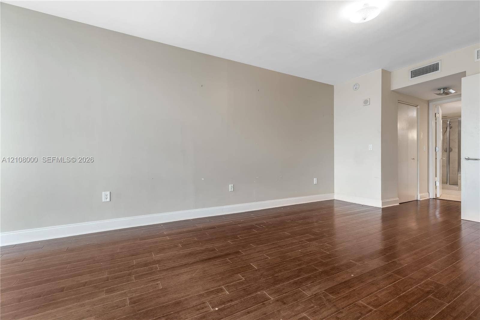 Aventura, FL 33180 Interior space featuring wood-finish flooring, neutral wall paint, and overhead flush-mount lighting