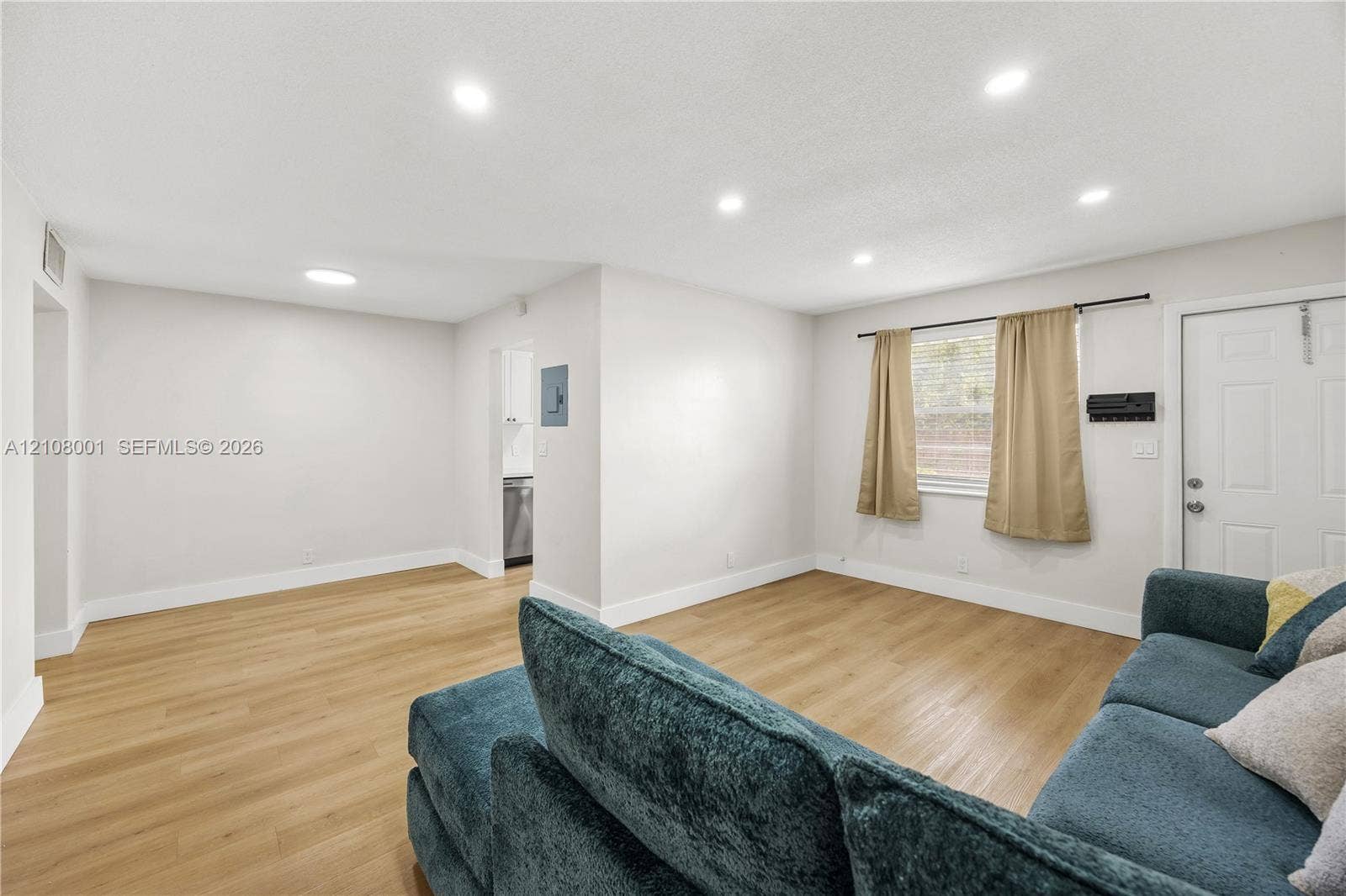 2418 Polk Street, #105, Hollywood, Hollywood, FL 33020 Open interior featuring wood-finish flooring, recessed lighting, and a paneled exterior entry door