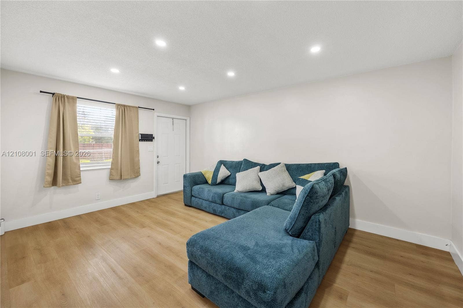 2418 Polk Street, #105, Hollywood, Hollywood, FL 33020 Interior space featuring wood-finish flooring, recessed lighting, and a single-panel door with hardware