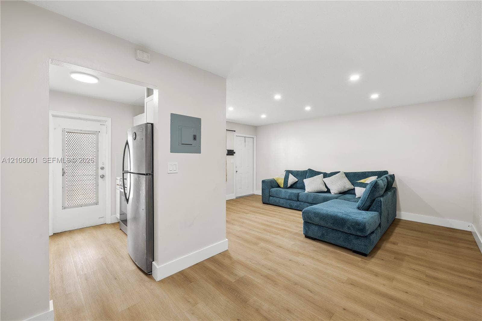 2418 Polk Street, #105, Hollywood, Hollywood, FL 33020 Open-concept interior featuring light wood-finish flooring, recessed lighting, and stainless steel kitchen appliances